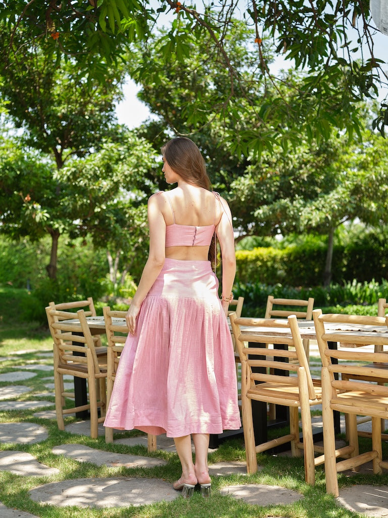 ROSELLE - A pink appliqué tie-up top paired with a fine pleated skirt.