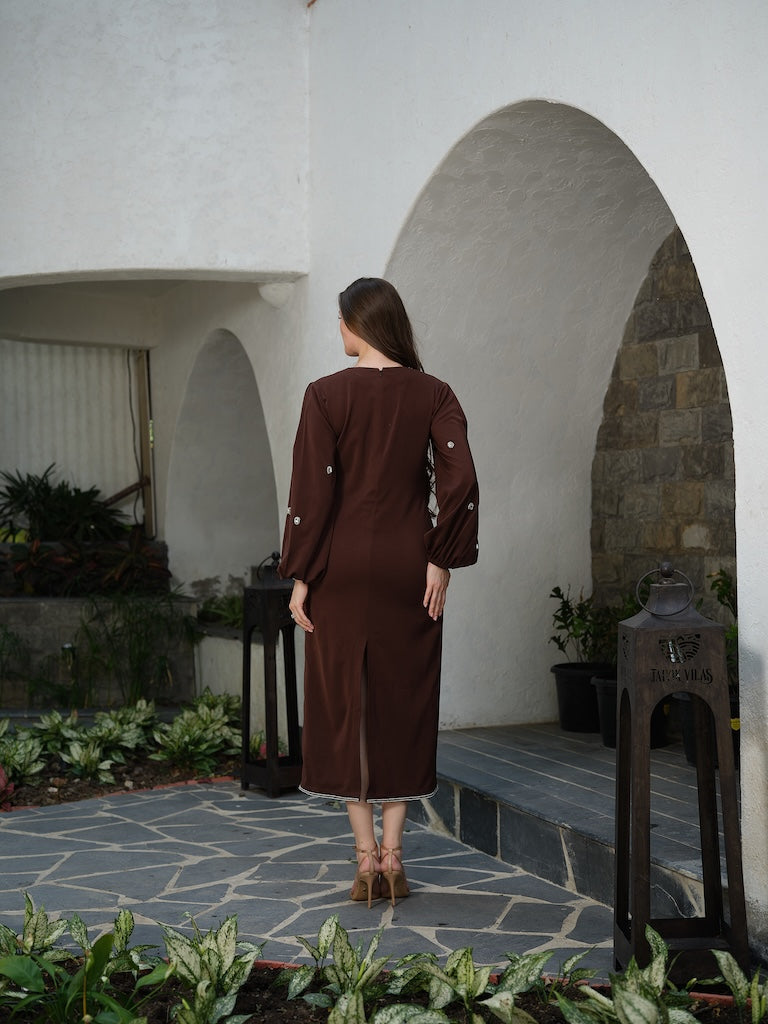 ORLANCE - A long brown dress with balloon sleeves and all-over stone scatter detailing.