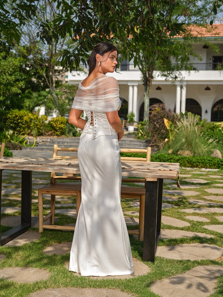 NAYORA - A white structured corset with ruched net back and latkan detailing paired with a fish-cut skirt.