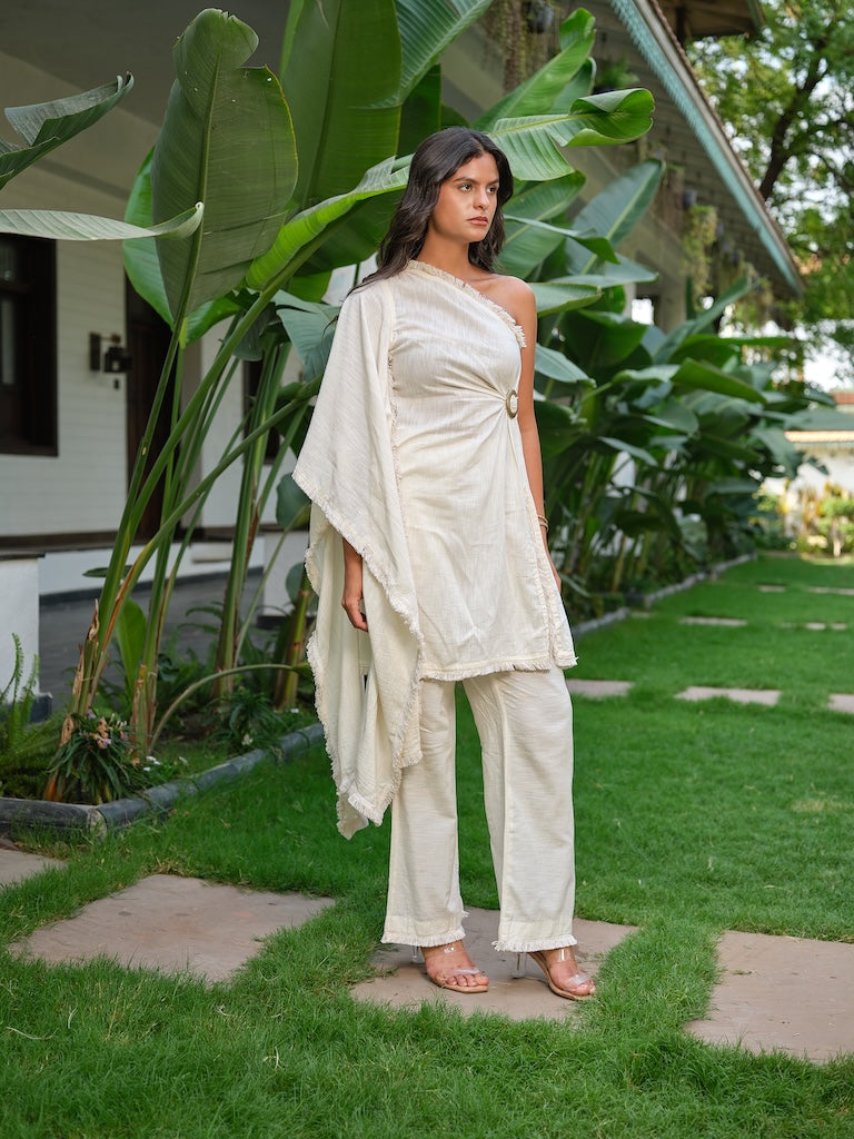 ELANTRA - A one-shoulder draped linen top with a metal buckle paired with straight pants.