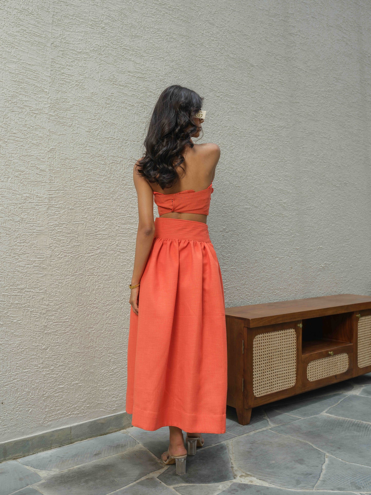 ELENA – Halter neck top paired with a skirt detailed at the waist