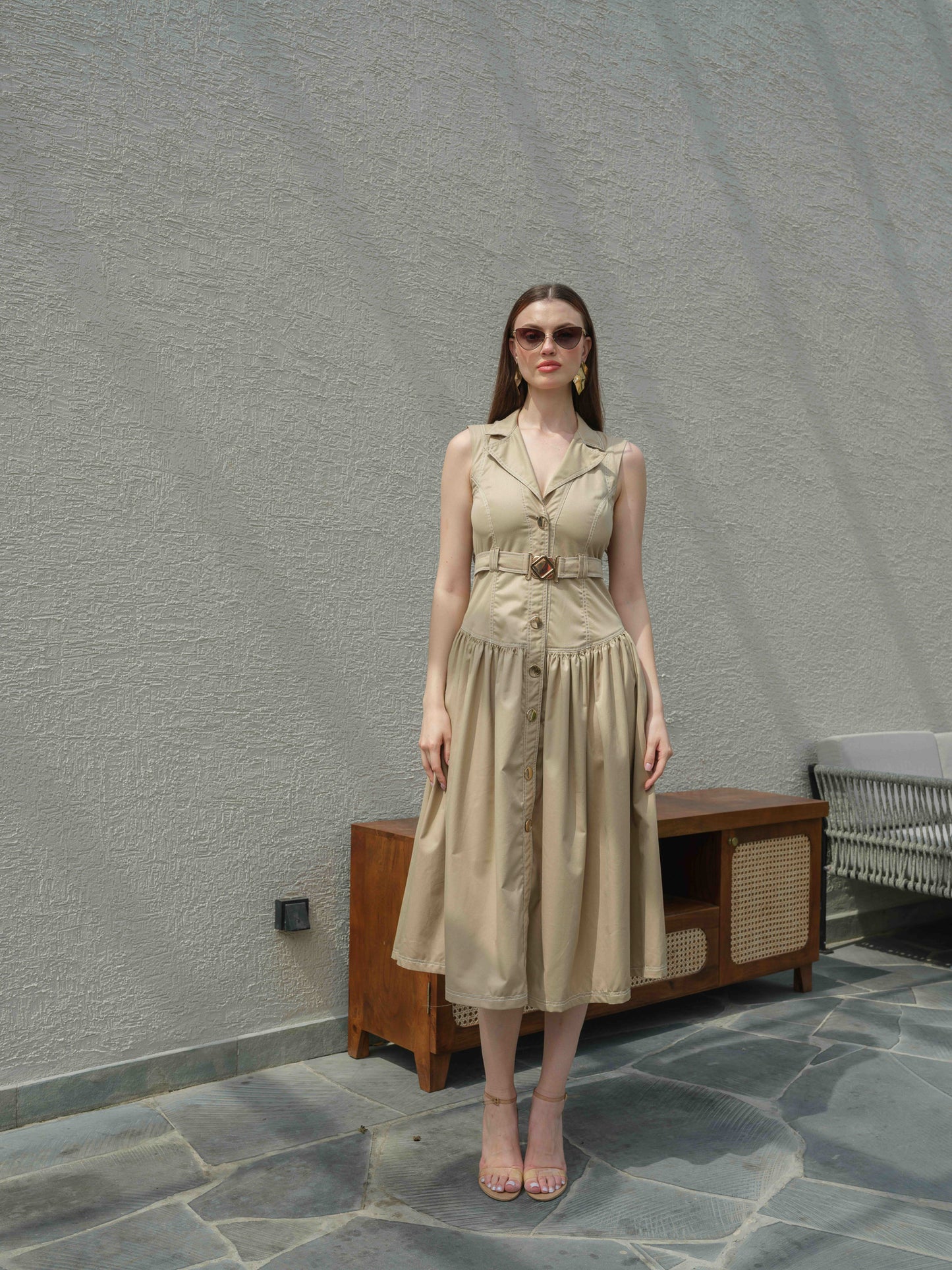 BUFFIE – A buff-colored dress with stone detailing and a belt featuring a metal buckle.