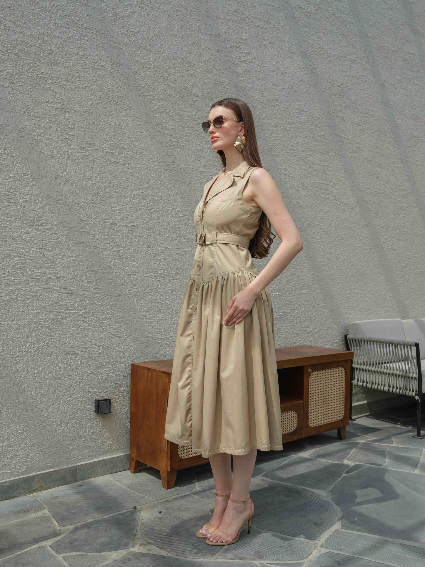BUFFIE – A buff-colored dress with stone detailing and a belt featuring a metal buckle.