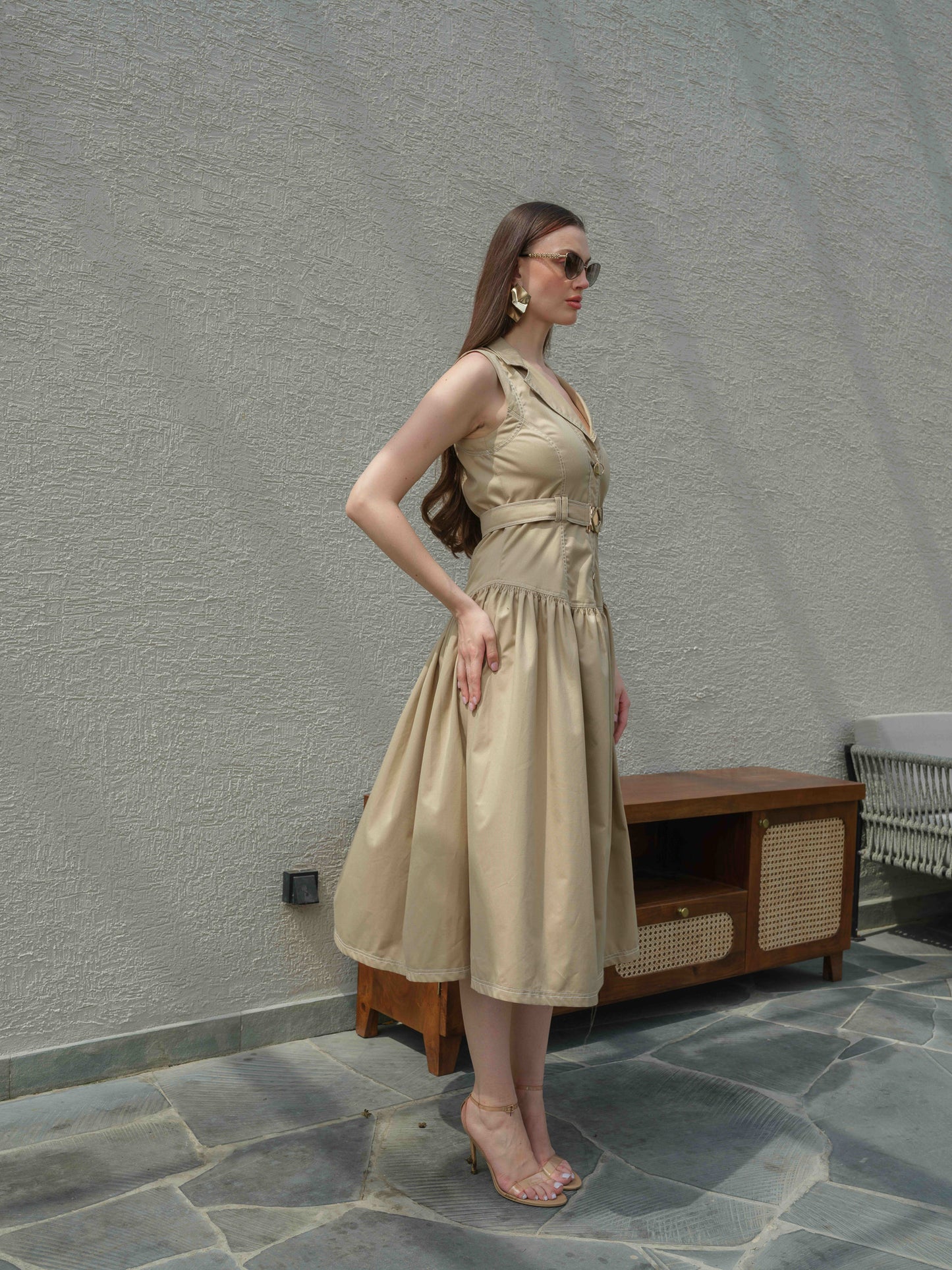 BUFFIE – A buff-colored dress with stone detailing and a belt featuring a metal buckle.