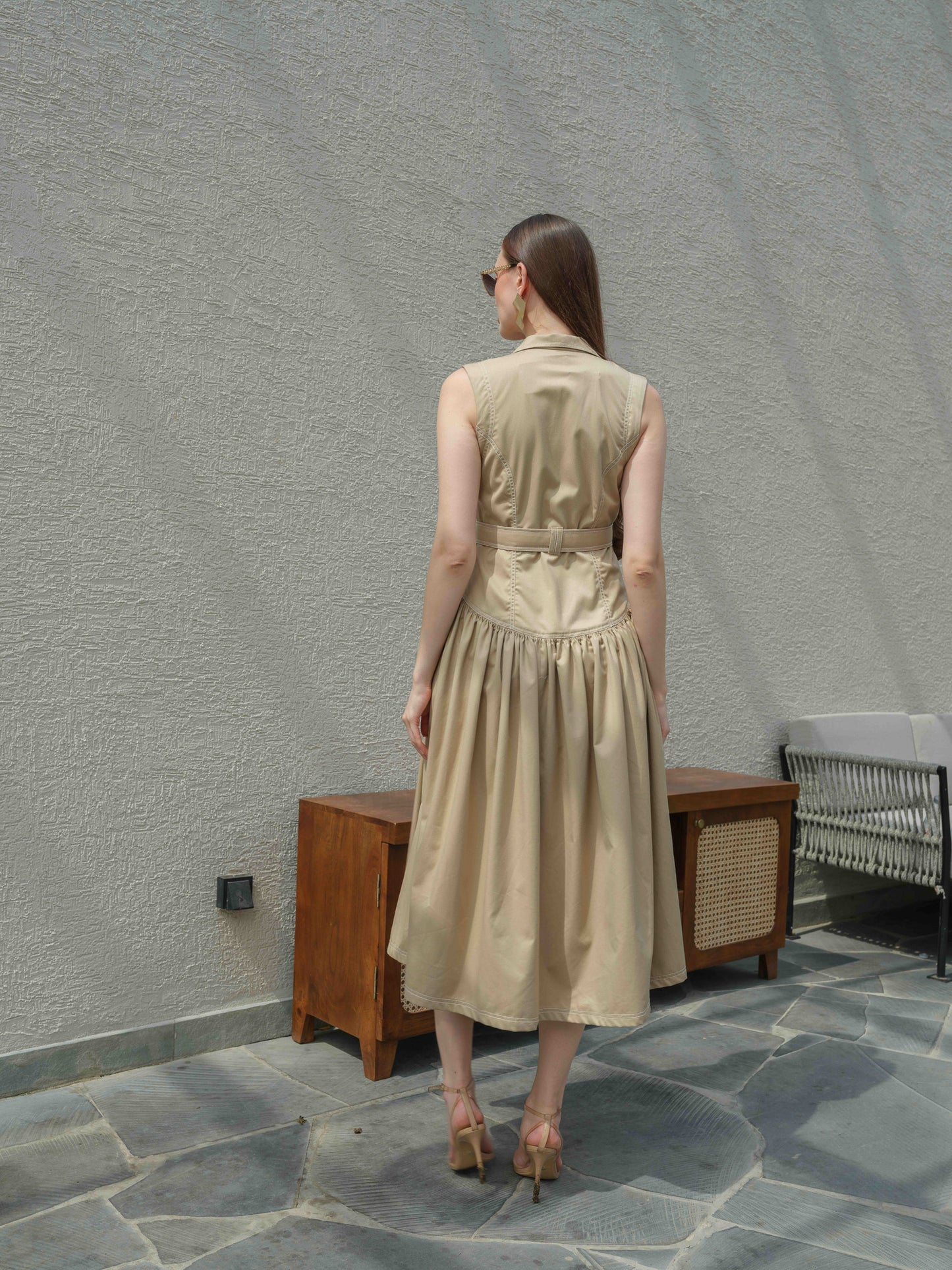 BUFFIE – A buff-colored dress with stone detailing and a belt featuring a metal buckle.