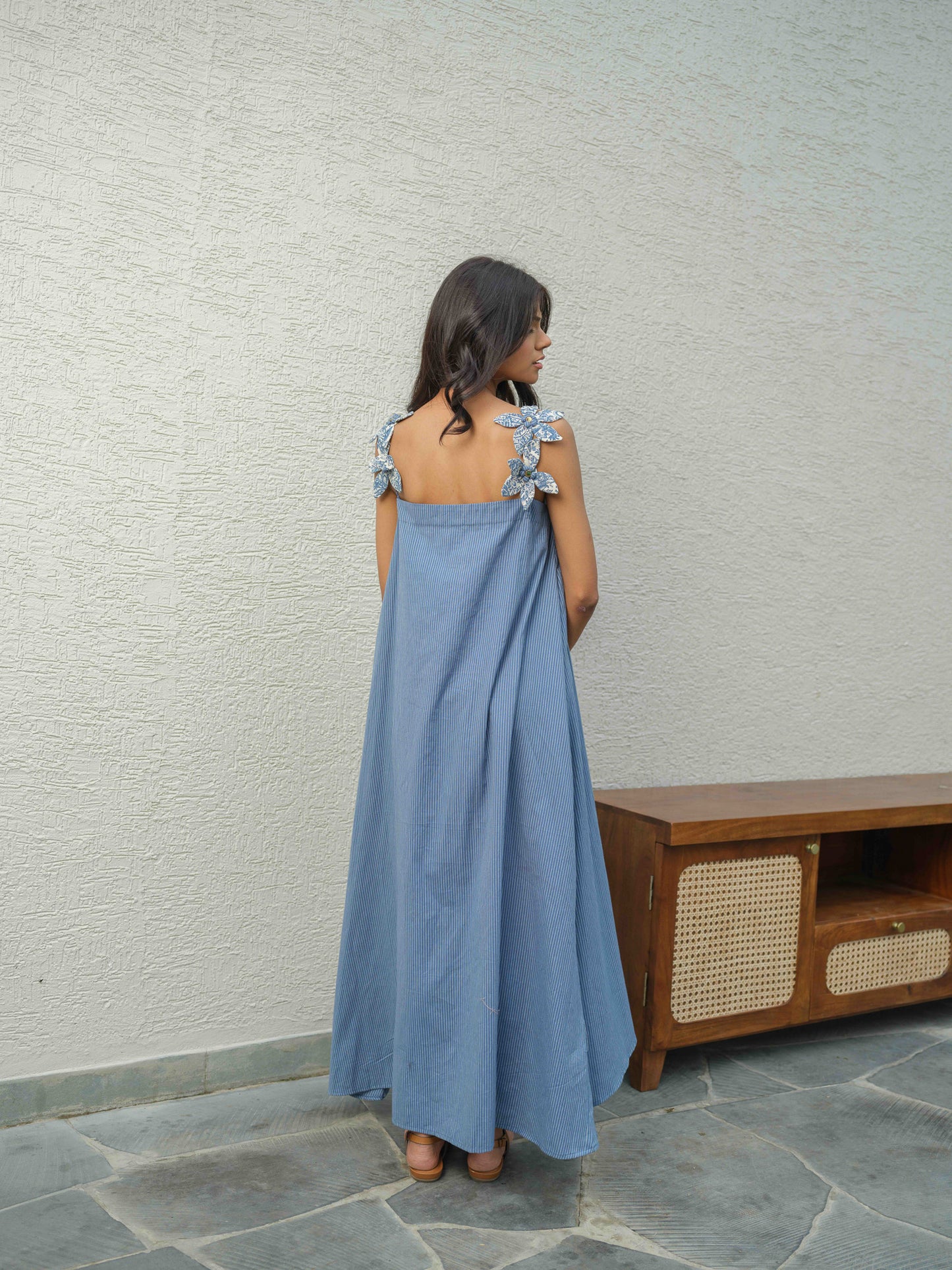 ZYRA – A blue dress with pleated neckline, flower detailing on the straps