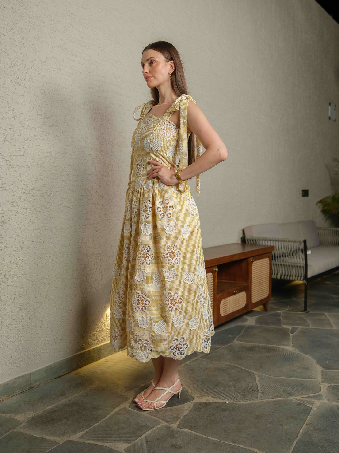 BREZELLA – A cutwork drop-waist dress featuring tie-up straps at the shoulders.