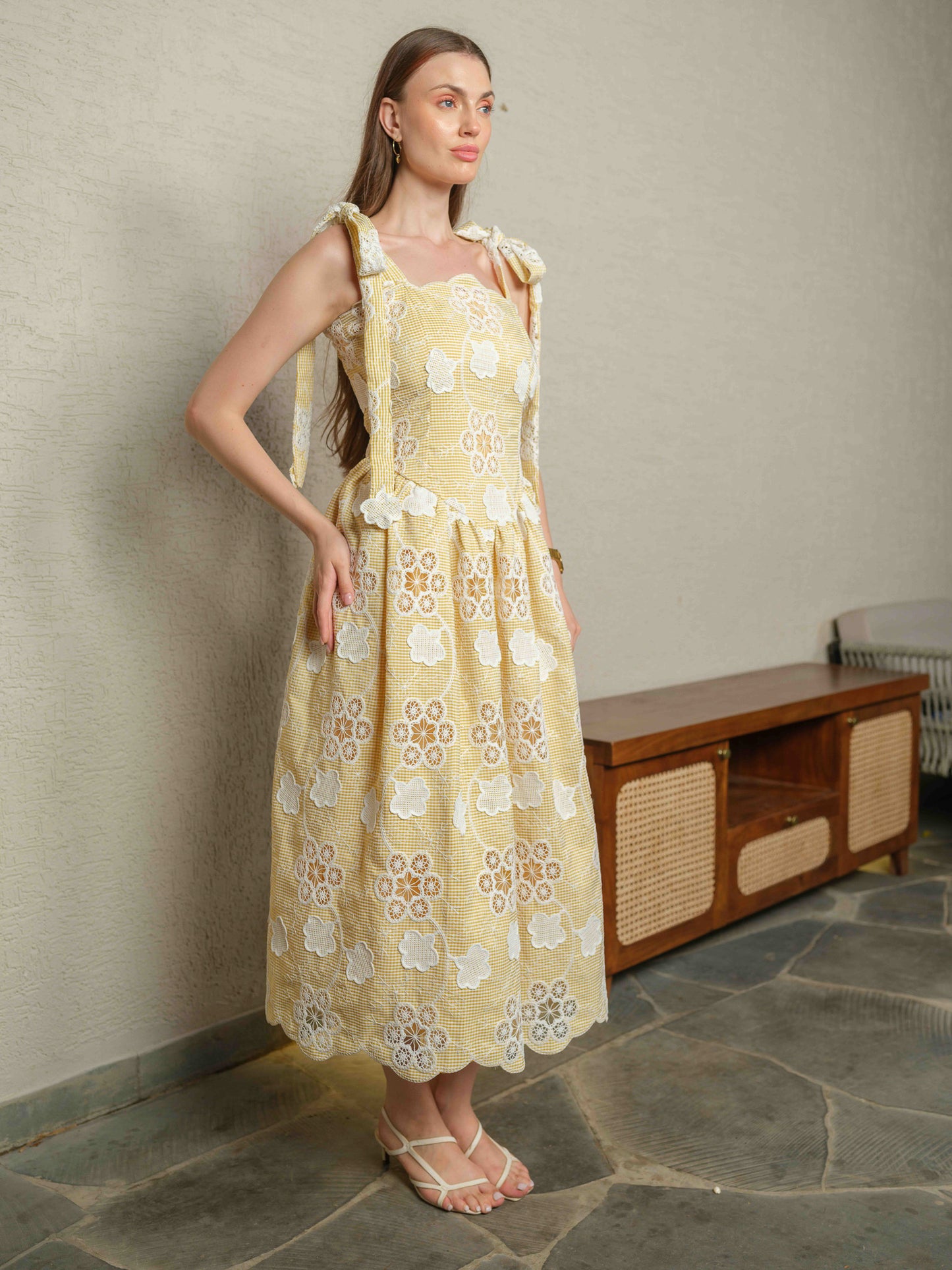 BREZELLA – A cutwork drop-waist dress featuring tie-up straps at the shoulders.