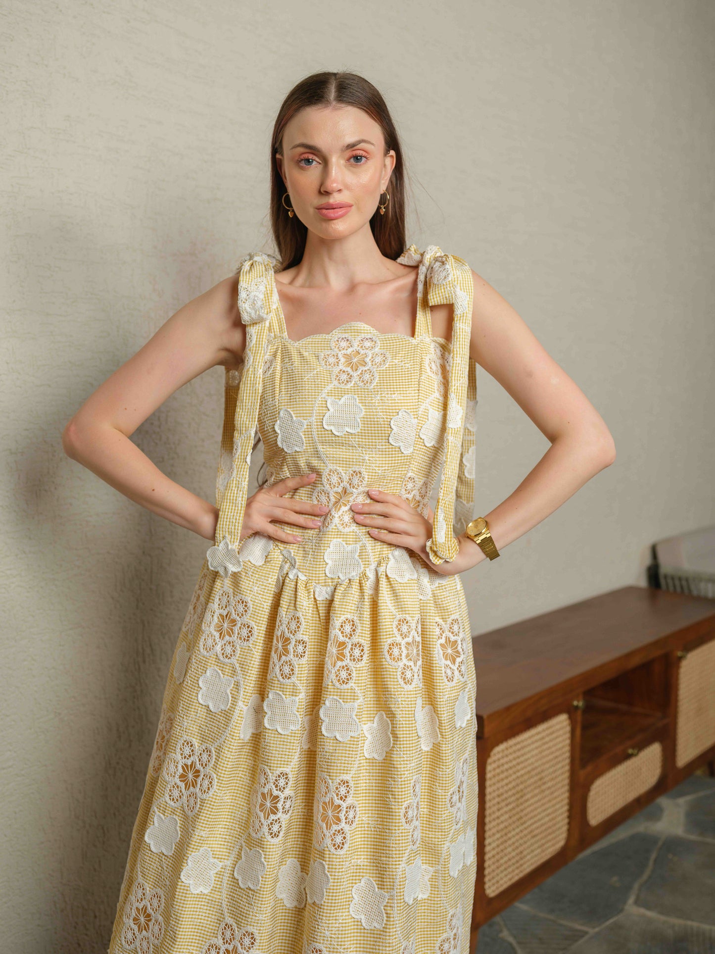 BREZELLA – A cutwork drop-waist dress featuring tie-up straps at the shoulders.