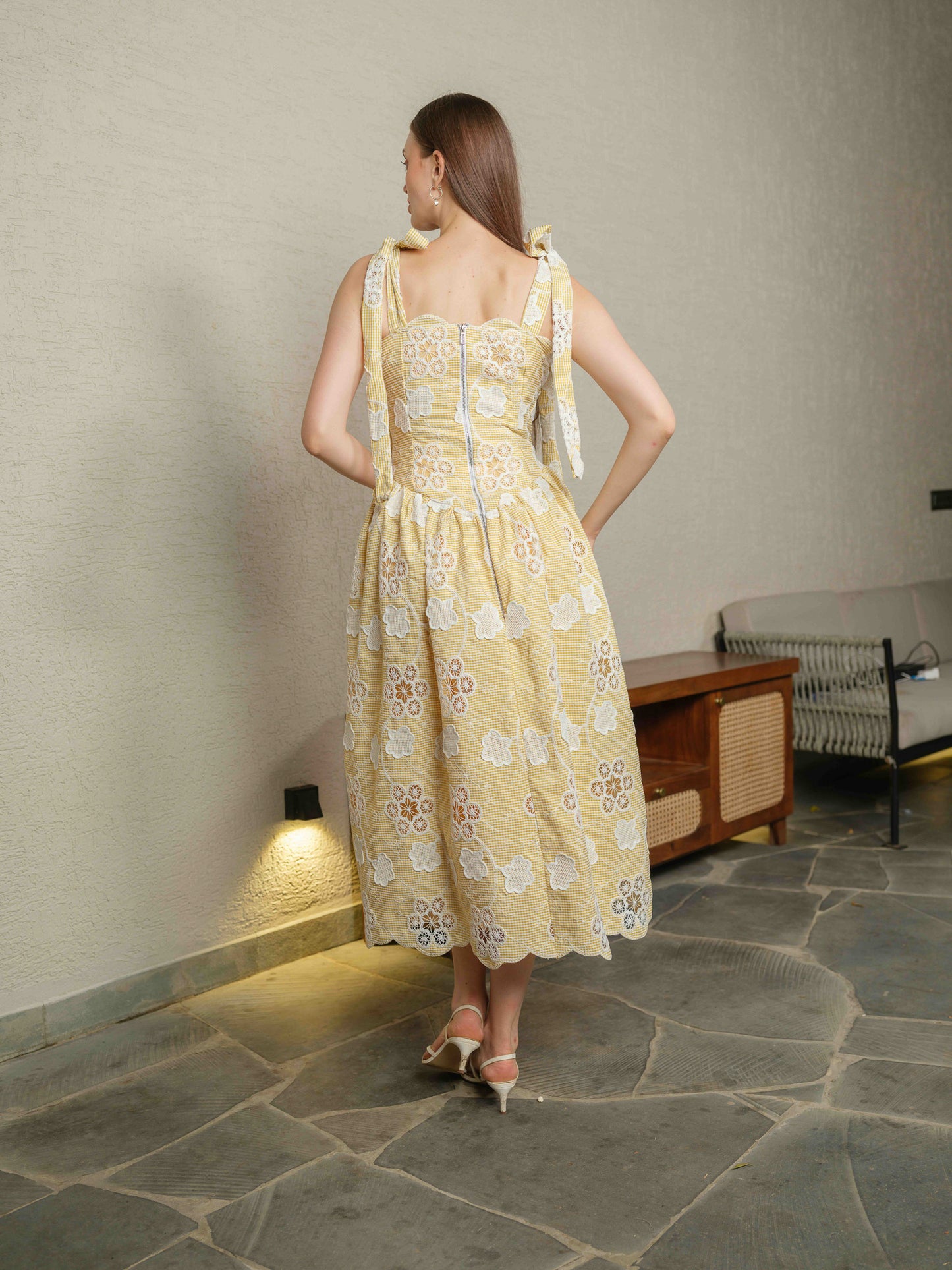 BREZELLA – A cutwork drop-waist dress featuring tie-up straps at the shoulders.