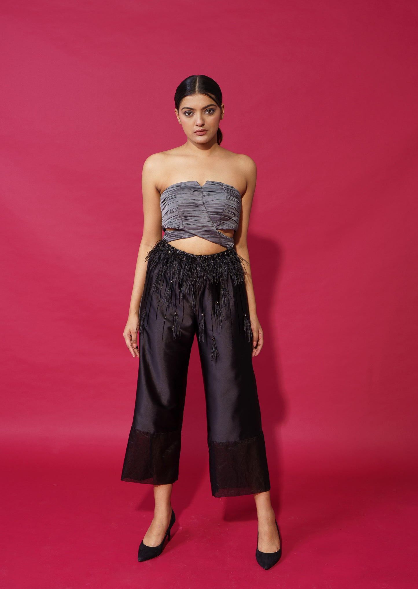 Paige - Ankle length jumpsuit with pleated bustier with feather detailing.