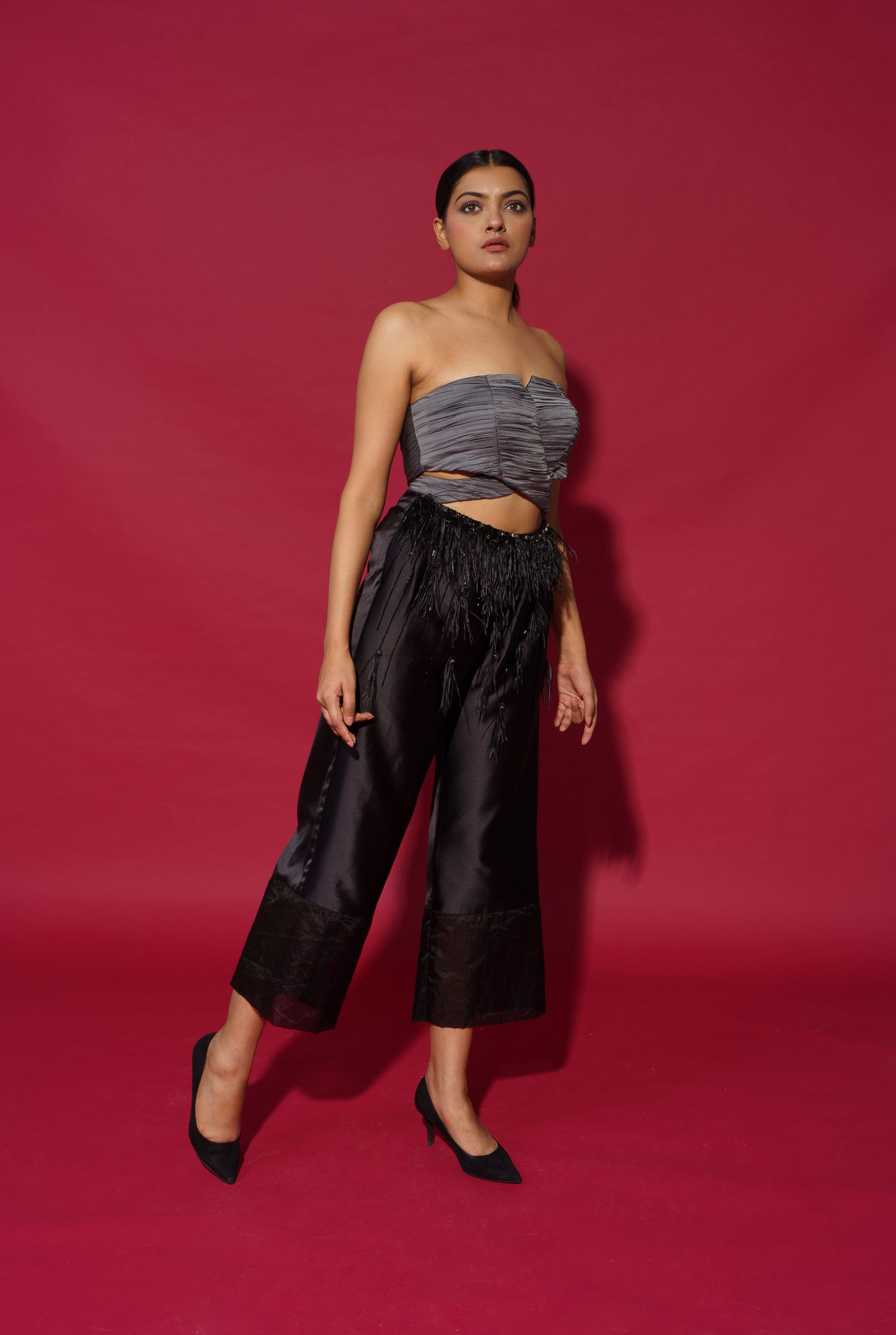 Paige - Ankle length jumpsuit with pleated bustier with feather detailing.