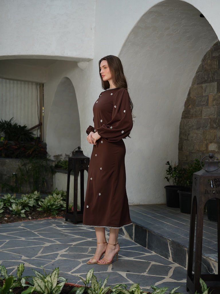 ORLANCE - A long brown dress with balloon sleeves and all-over stone scatter detailing.