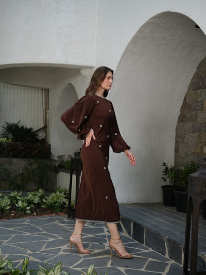 ORLANCE - A long brown dress with balloon sleeves and all-over stone scatter detailing.