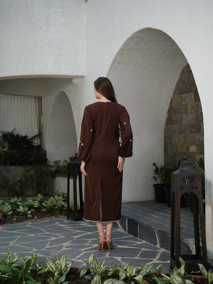 ORLANCE - A long brown dress with balloon sleeves and all-over stone scatter detailing.