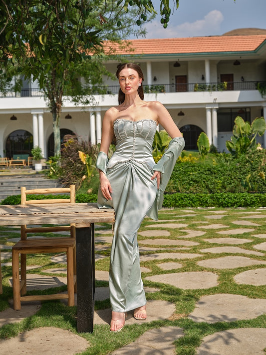 SIENNA GRACE - A mint green corset with stone, pearl, and pleated detailing paired with a draped skirt.