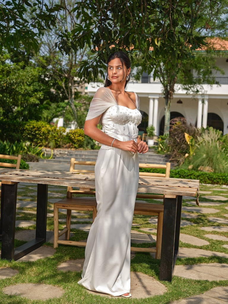 NAYORA - A white structured corset with ruched net back and latkan detailing paired with a fish-cut skirt.