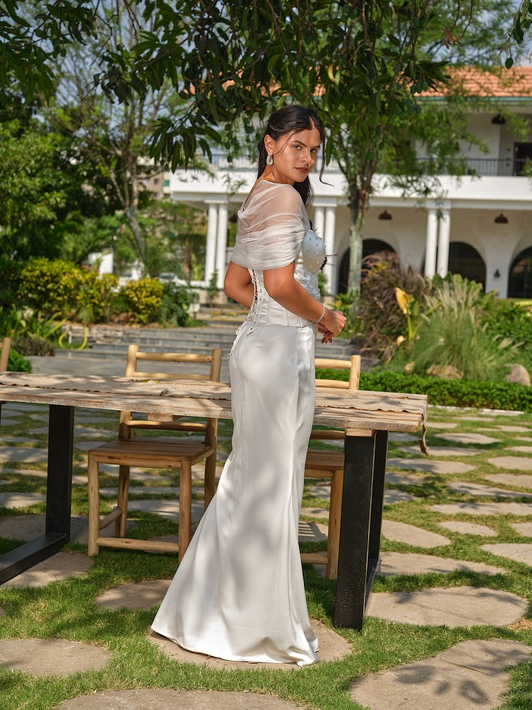 NAYORA - A white structured corset with ruched net back and latkan detailing paired with a fish-cut skirt.