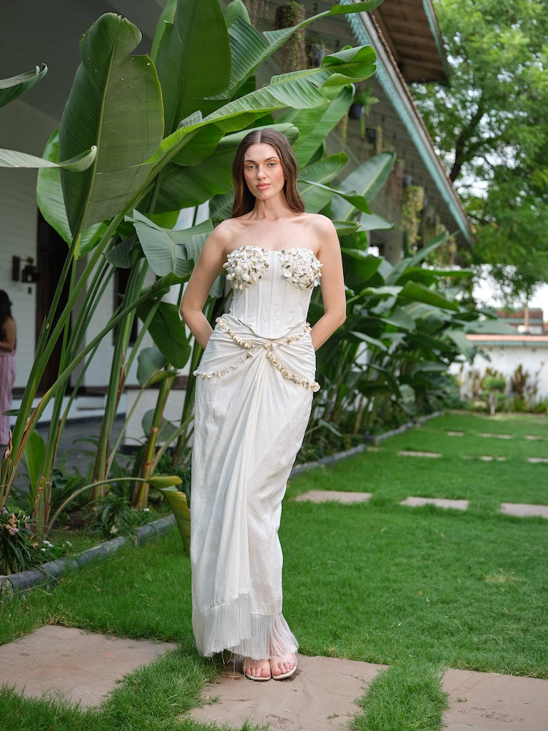 LILESSA - An ivory corset with 3D floral detailing and a draped skirt.
