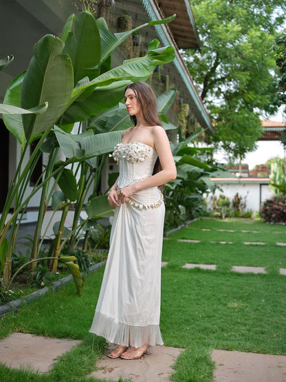 LILESSA - An ivory corset with 3D floral detailing and a draped skirt.