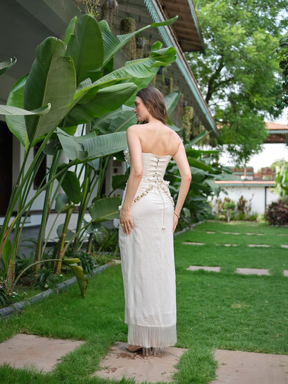 LILESSA - An ivory corset with 3D floral detailing and a draped skirt.
