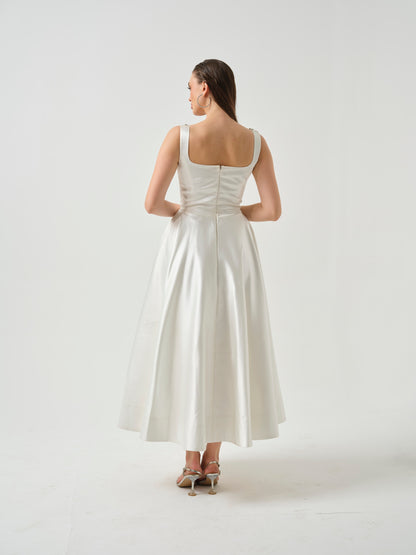 LILY- white T-length dress with stone detailing .