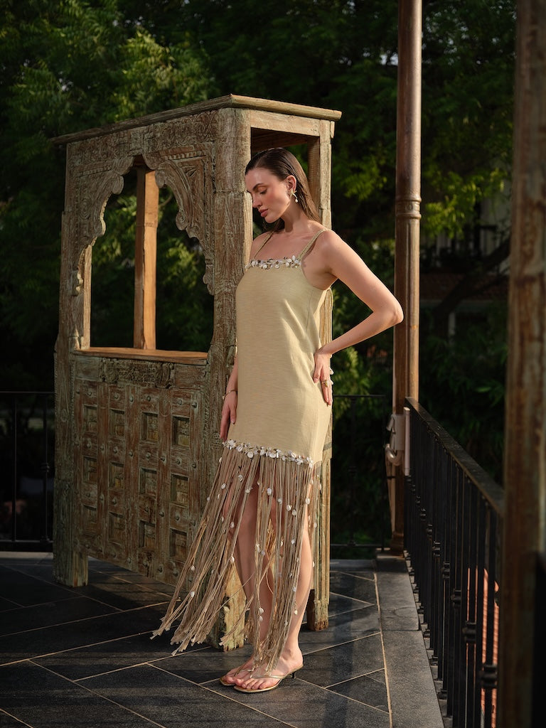 AVELORA - A chic beige mini dress with shell detailing and statement dori at the hem