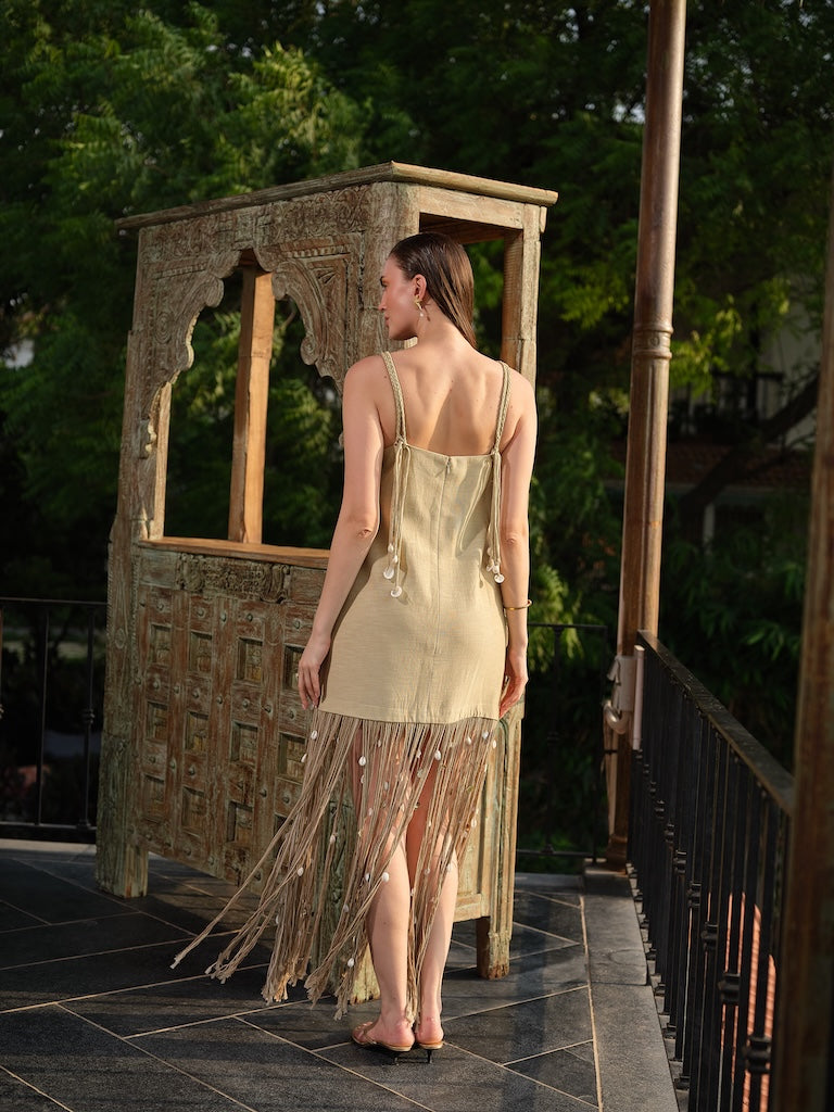 AVELORA - A chic beige mini dress with shell detailing and statement dori at the hem
