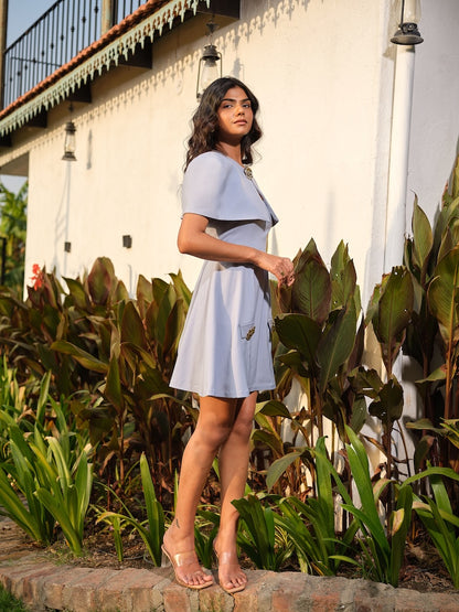 CINDERIA - A powder blue A-line dress with metal button flap detailing, paired with a matching cap