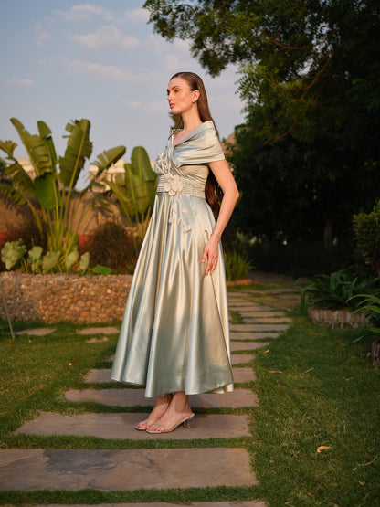 CAMELLIA -A mint green tea-length dress with elegant pleating at the waist and a halterneck with a soft flap detail.