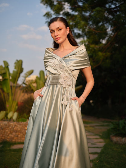 CAMELLIA -A mint green tea-length dress with elegant pleating at the waist and a halterneck with a soft flap detail.