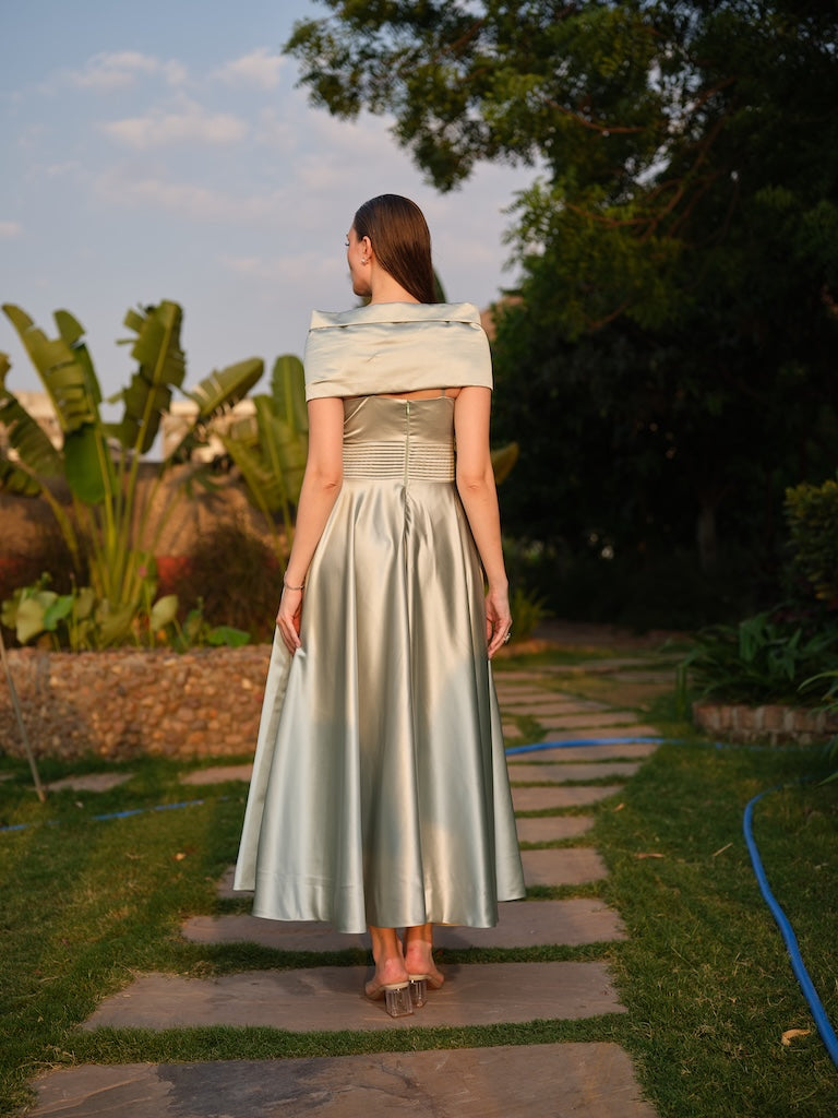 CAMELLIA -A mint green tea-length dress with elegant pleating at the waist and a halterneck with a soft flap detail.