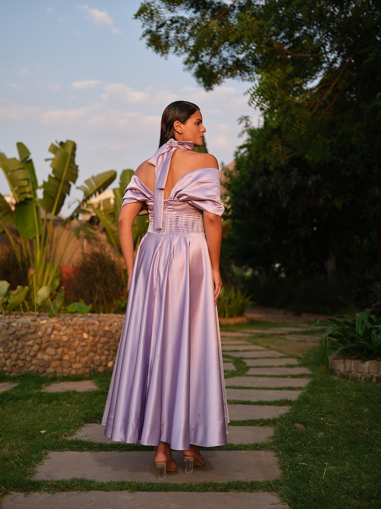 ROSALIE - A lilac tea-length dress with elegant pleating at the waist and a halterneck with a soft flap detail.