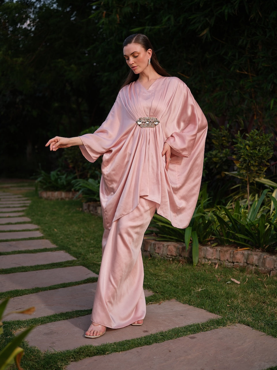 LISETTE - A peach satin kaftan with elegant front pleating Paired with a self-tie drape skirt