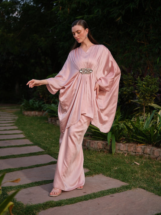 LISETTE - A peach satin kaftan with elegant front pleating Paired with a self-tie drape skirt