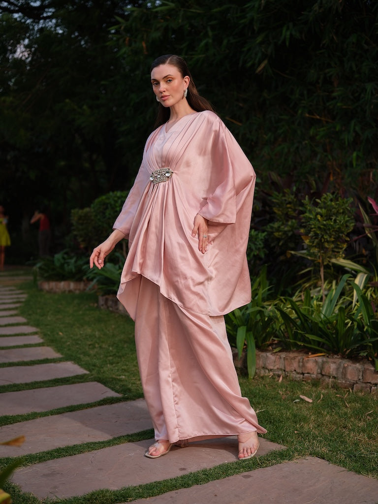 LISETTE - A peach satin kaftan with elegant front pleating Paired with a self-tie drape skirt