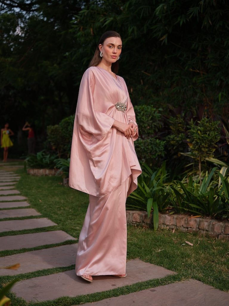 LISETTE - A peach satin kaftan with elegant front pleating Paired with a self-tie drape skirt
