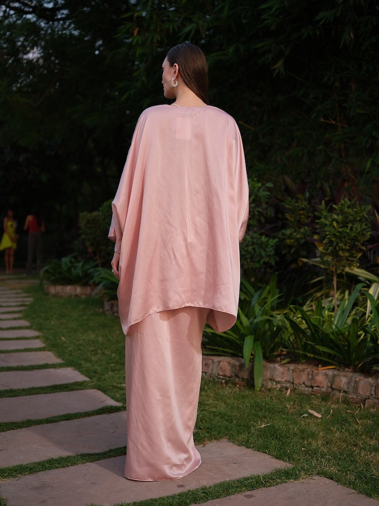 LISETTE - A peach satin kaftan with elegant front pleating Paired with a self-tie drape skirt