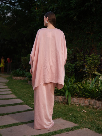 LISETTE - A peach satin kaftan with elegant front pleating Paired with a self-tie drape skirt
