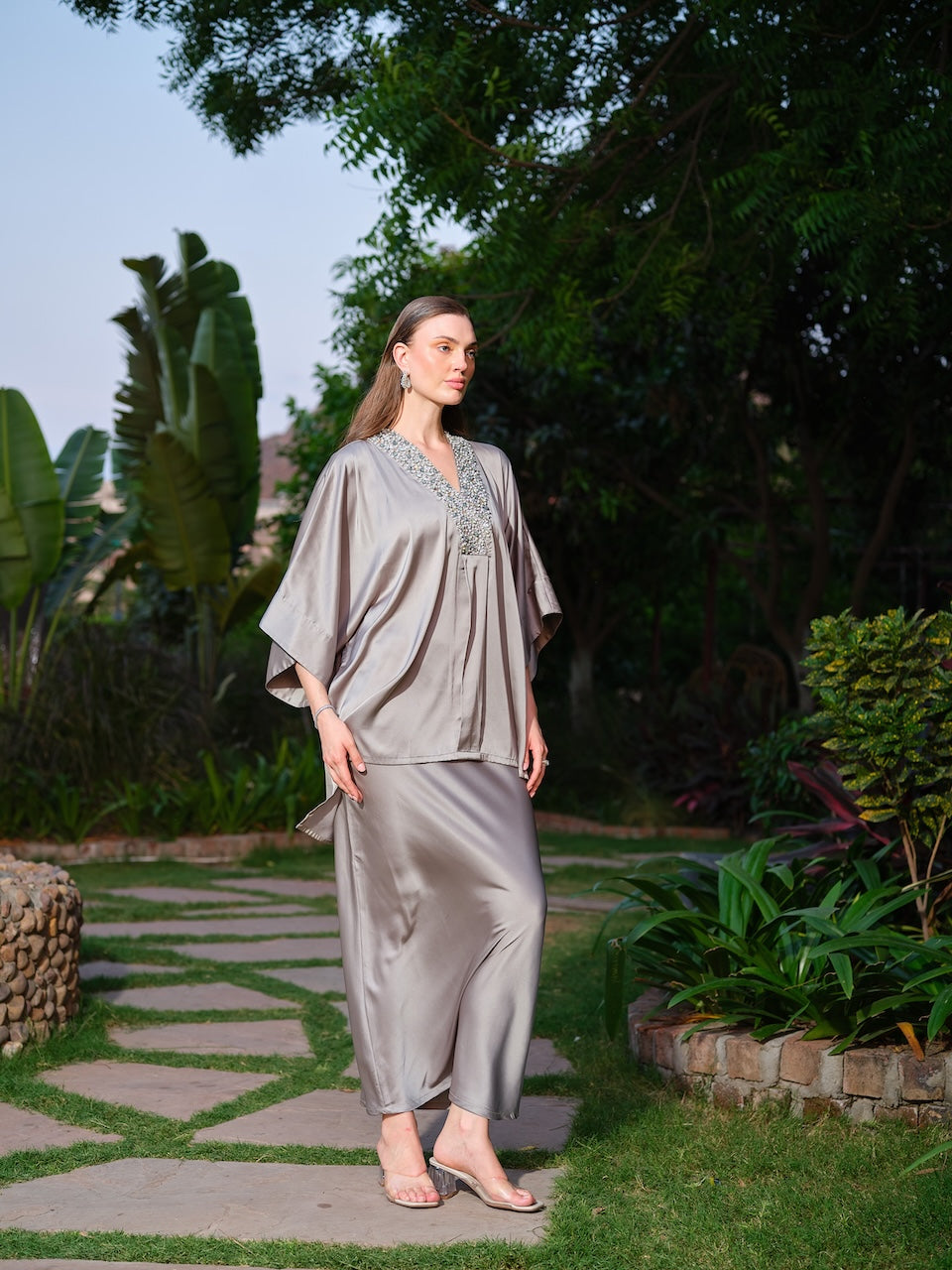 VIOLAINE - A green kaftan top featuring intricate detailing along the neckline. Paired with a sleek straight satin skirt