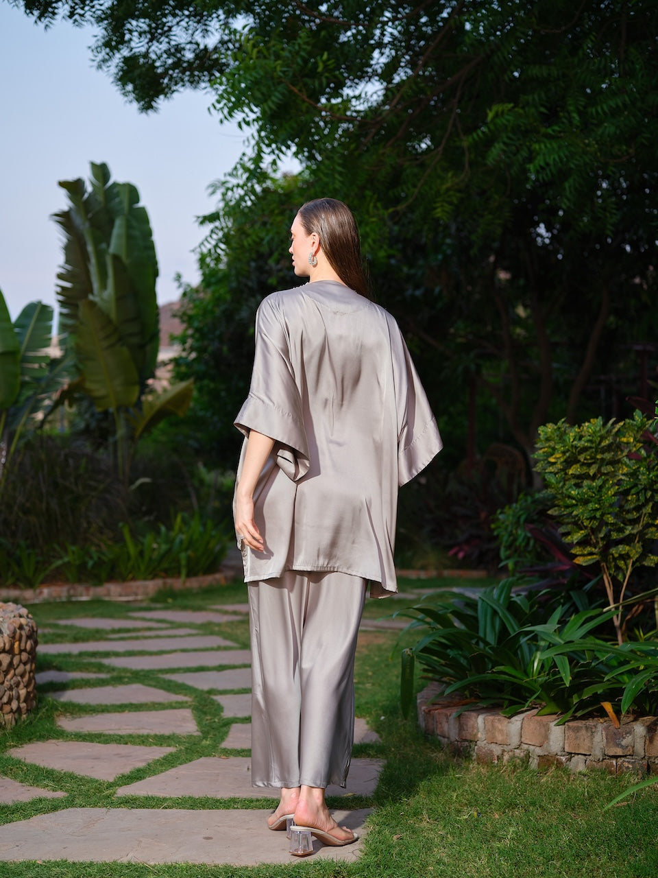 VIOLAINE - A green kaftan top featuring intricate detailing along the neckline. Paired with a sleek straight satin skirt