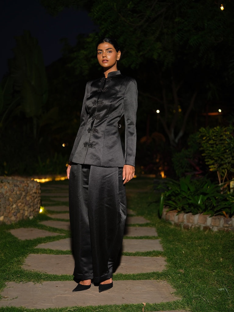 ANOURA - A black satin co-ord set with full sleeves and a mandarin collar,  Paired with barrel pants