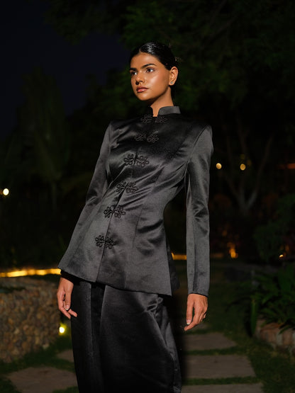 ANOURA - A black satin co-ord set with full sleeves and a mandarin collar,  Paired with barrel pants