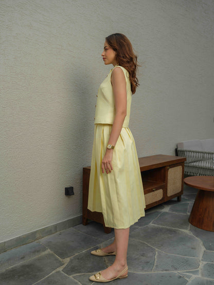 ZEST –  co-ord set with a sleeveless jacket featuring button detailing, paired with a box-pleated skirt
