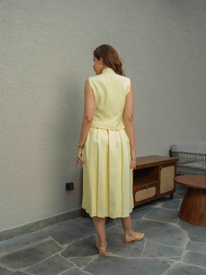 ZEST –  co-ord set with a sleeveless jacket featuring button detailing, paired with a box-pleated skirt