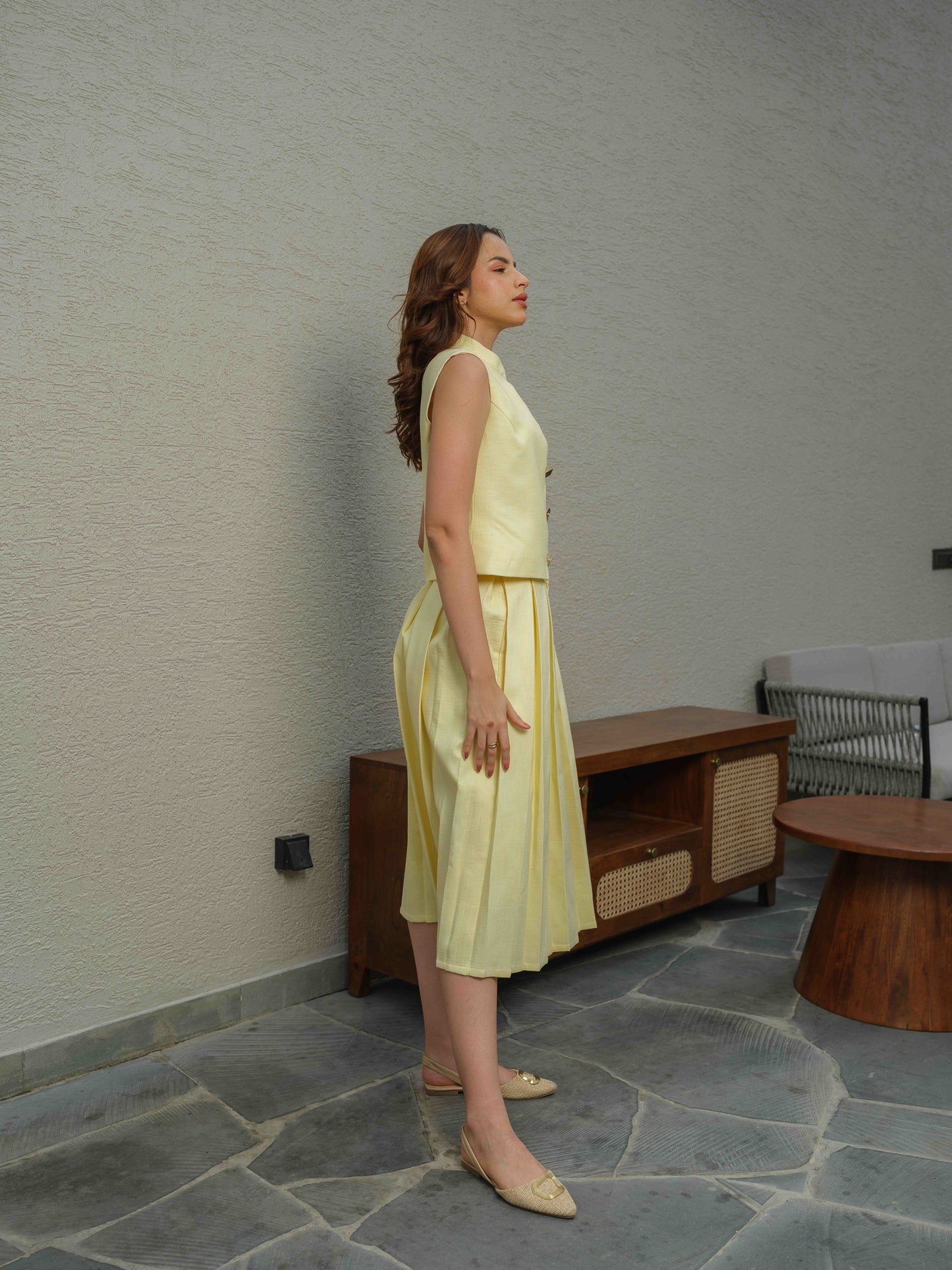 ZEST –  co-ord set with a sleeveless jacket featuring button detailing, paired with a box-pleated skirt