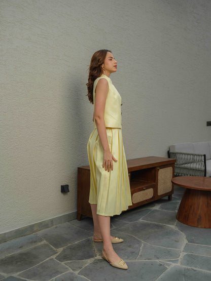 ZEST –  co-ord set with a sleeveless jacket featuring button detailing, paired with a box-pleated skirt