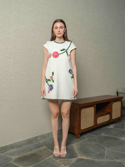 VENICE – A  white box-fit dress featuring exquisite applique work with 3D embroidery.