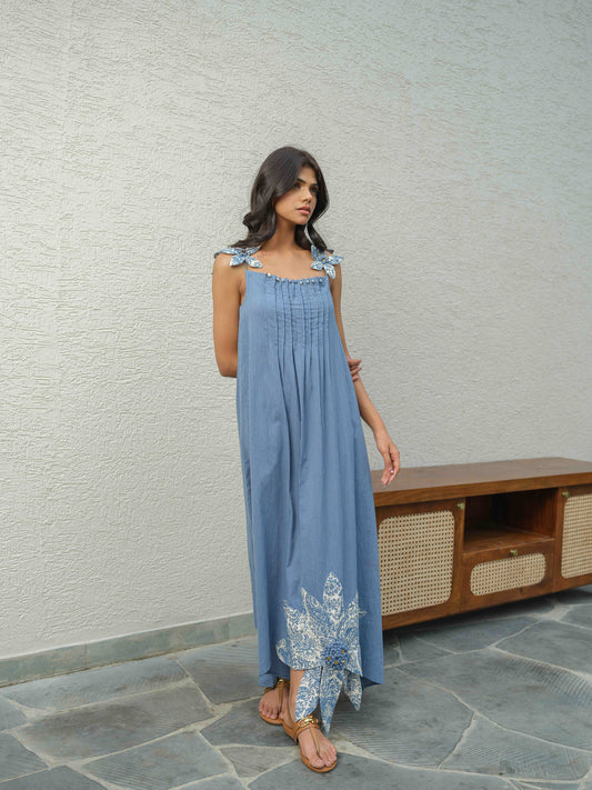 ZYRA – A blue dress with pleated neckline, flower detailing on the straps