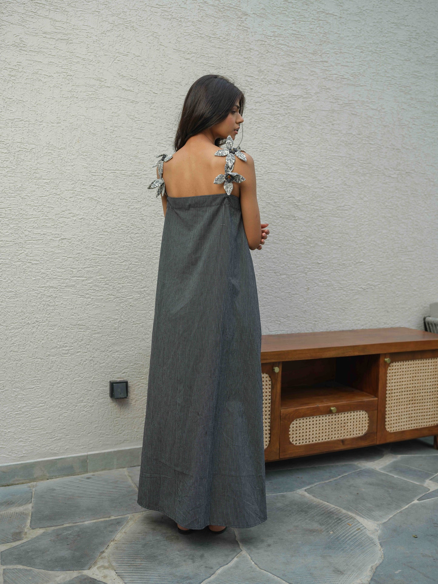 VETRA – A BLACK  dress with pleated neckline, flower detailing on the straps